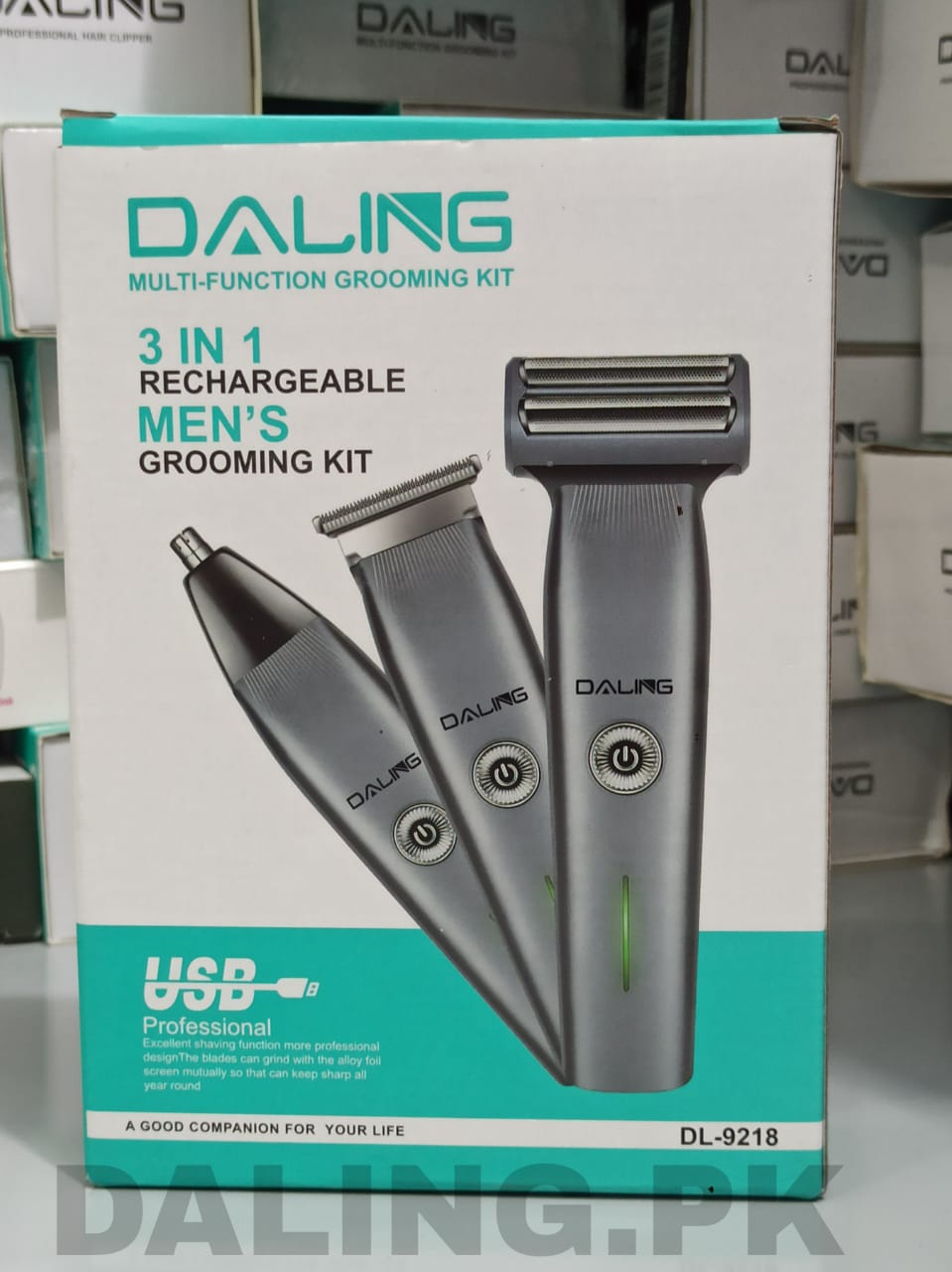 The image shows the packaging of DALING DL-9218 3 in 1 rechargeable hair clipper shaver. The product is visible through a clear window on the box, displaying the black colored clipper along with its accessories.